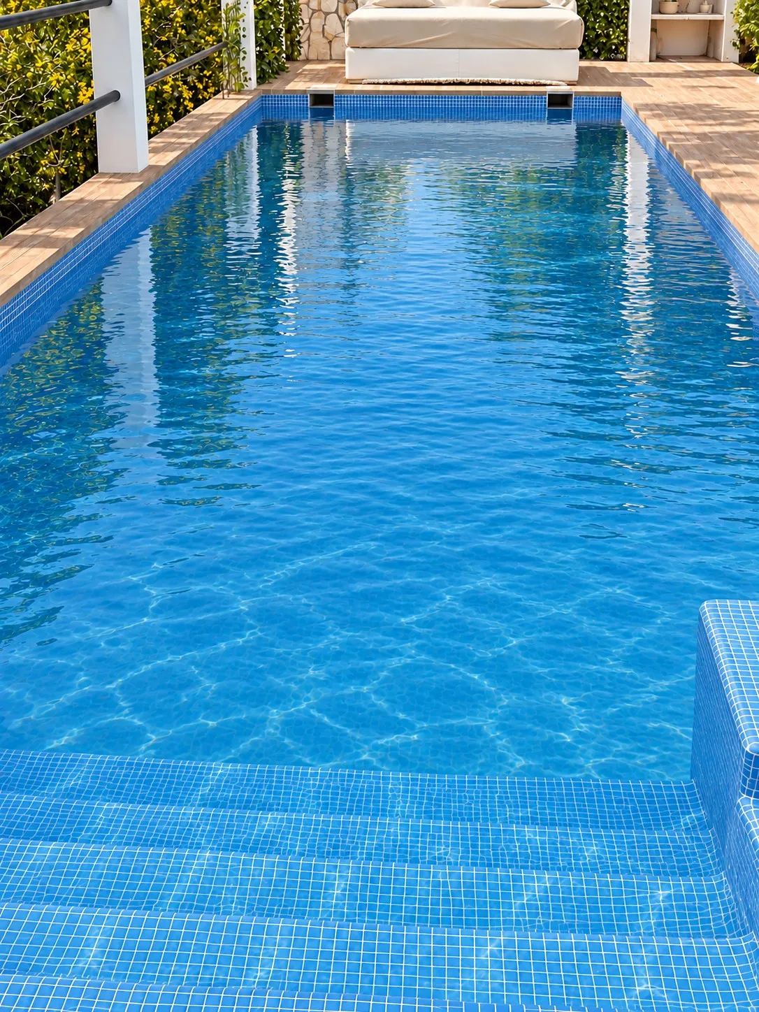 The same villa pool after treatment, crystal clear water